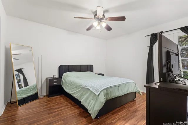 a bedroom with a large bed and a chandelier