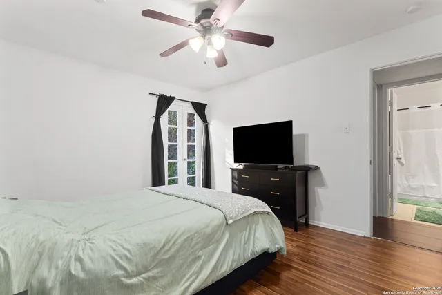 a bedroom with a bed and a flat screen tv