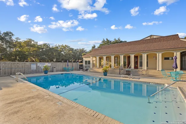 a view of a house with pool and a yard