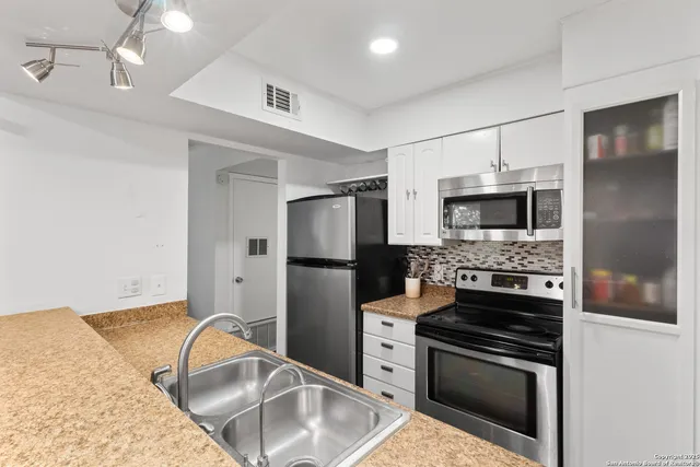 a kitchen with a refrigerator stove and microwave