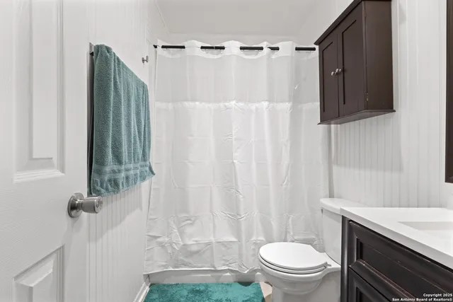 a bathroom with a toilet a sink and garden