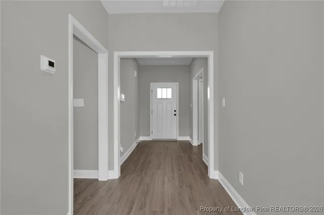 a view of a hallway with wooden floor