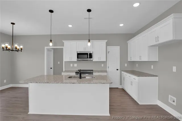 a large kitchen with stainless steel appliances kitchen island a large island in the center