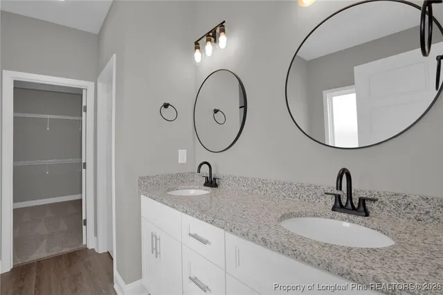 a bathroom with a double vanity sink and a mirror