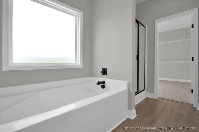 a bathroom with a bathtub and a window