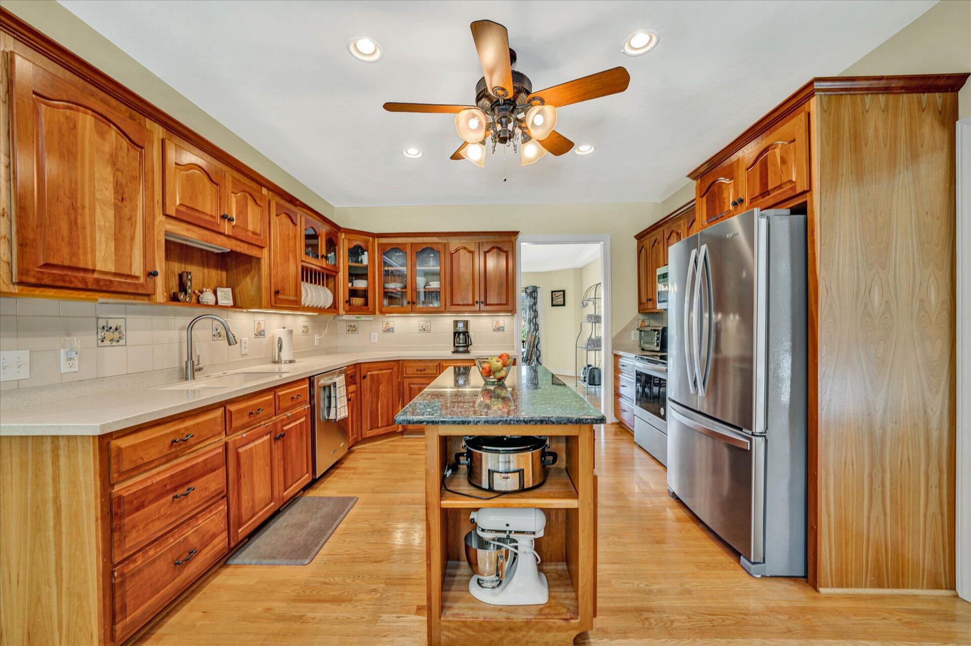 325 Rock Ridge Road Callaway, VA 24067 - Photo 17 of 74 a kitchen with stainless steel appliances granite countertop a refrigerator a sink dishwasher a stove and a dining table with wooden floor