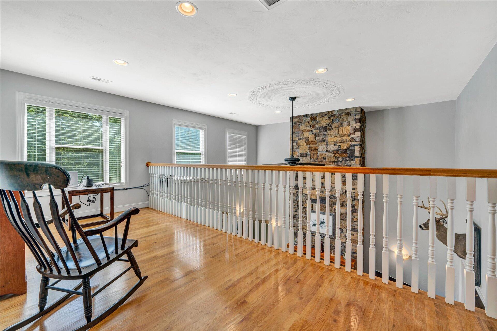325 Rock Ridge Road Callaway, VA 24067 - Photo 39 of 74 a view of a hallway with wooden floor and a staircase