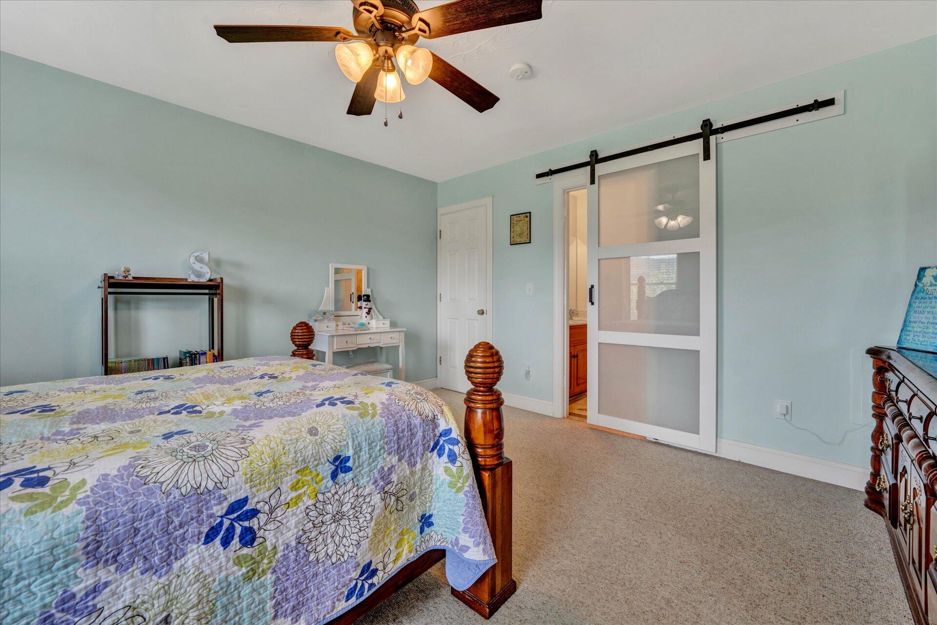 325 Rock Ridge Road Callaway, VA 24067 - Photo 47 of 74 a bedroom with a bed and a chandelier