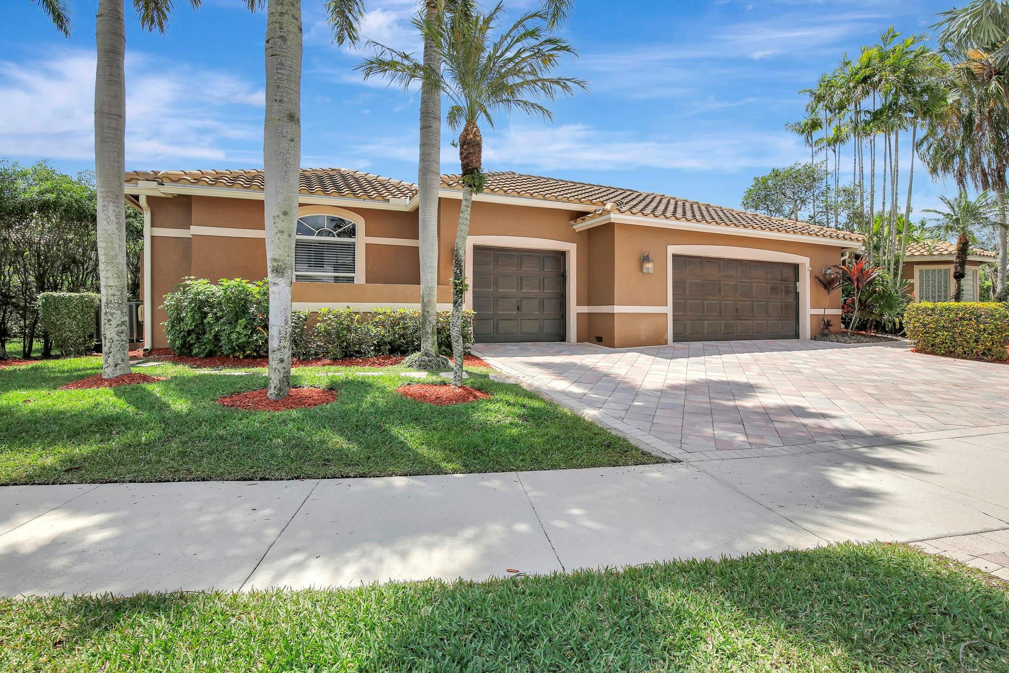 2529 Eagle Run Circle Fort Lauderdale, FL 33327 - Photo 11 of 74 front view of a house with a yard and an trees