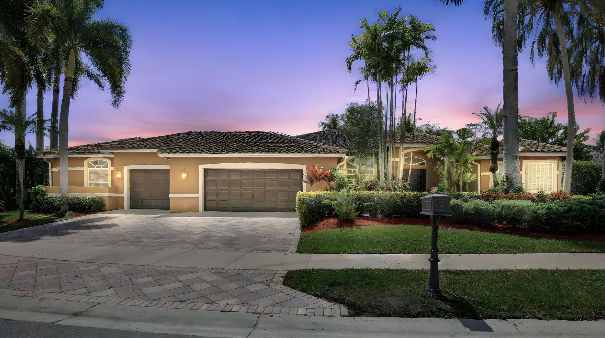 2529 Eagle Run Circle Fort Lauderdale, FL 33327 - Photo 12 of 74 a front view of a house with a garden and yard
