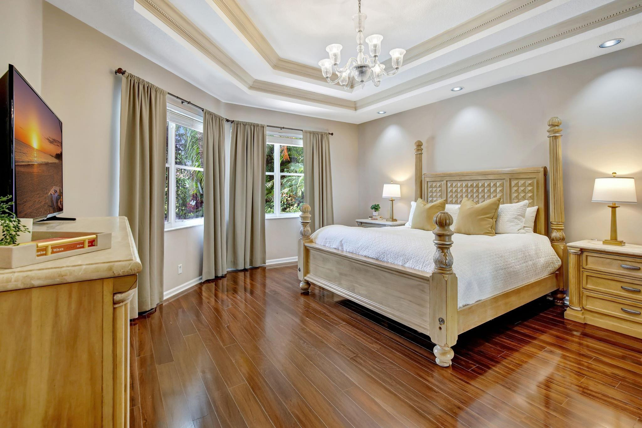 2529 Eagle Run Circle Fort Lauderdale, FL 33327 - Photo 40 of 74 a bedroom with a large bed and a flat tv screen on dresser