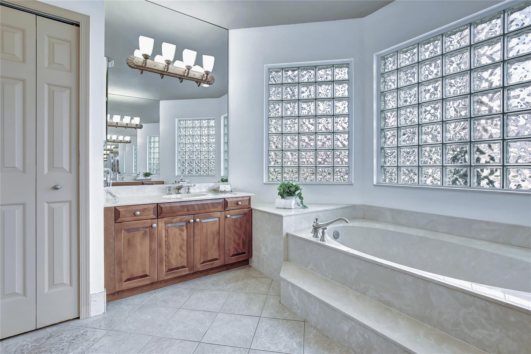2529 Eagle Run Circle Fort Lauderdale, FL 33327 - Photo 46 of 74 a spacious bathroom with a granite countertop tub sink and mirror