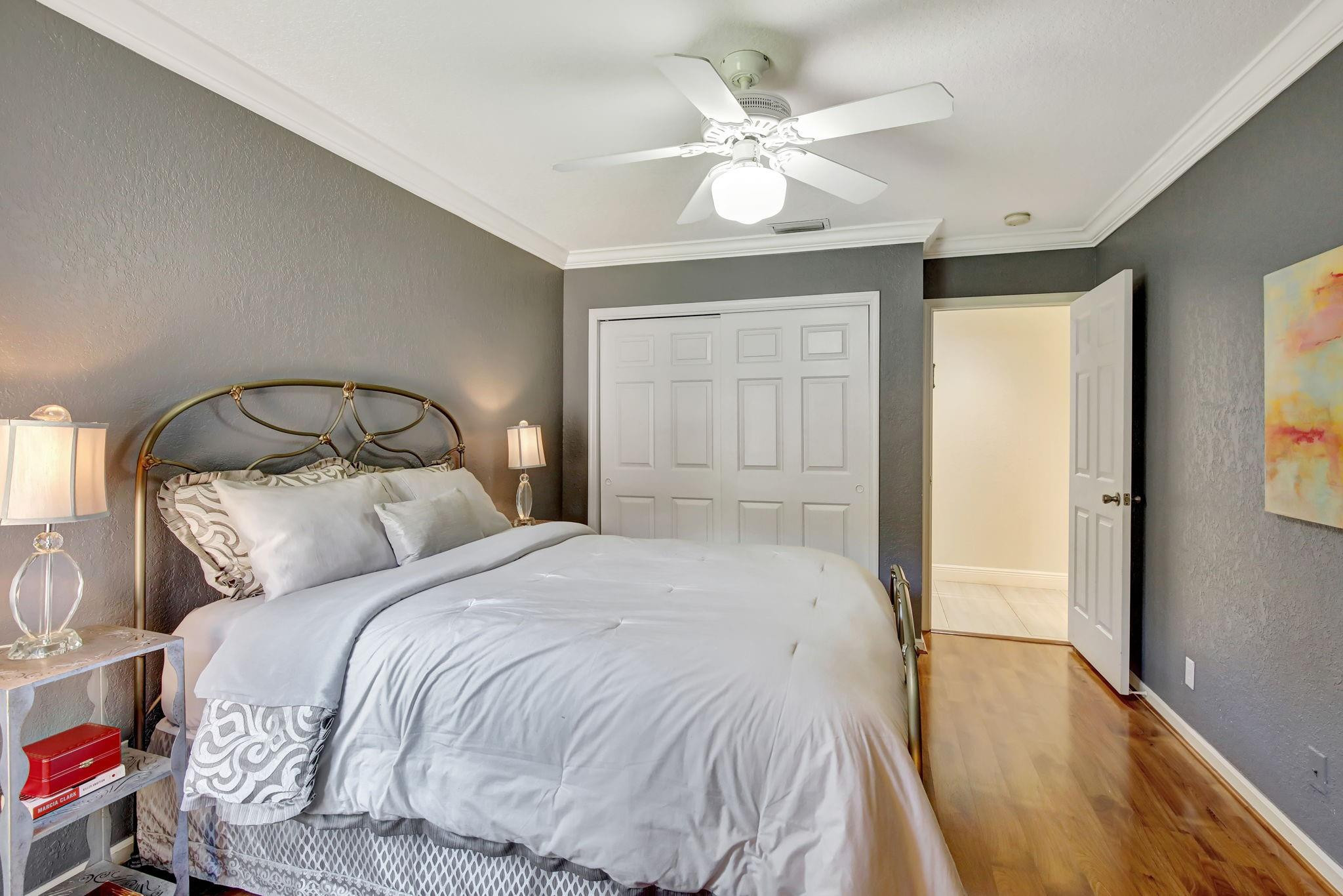 2529 Eagle Run Circle Fort Lauderdale, FL 33327 - Photo 57 of 74 a bedroom with a large bed and a chandelier