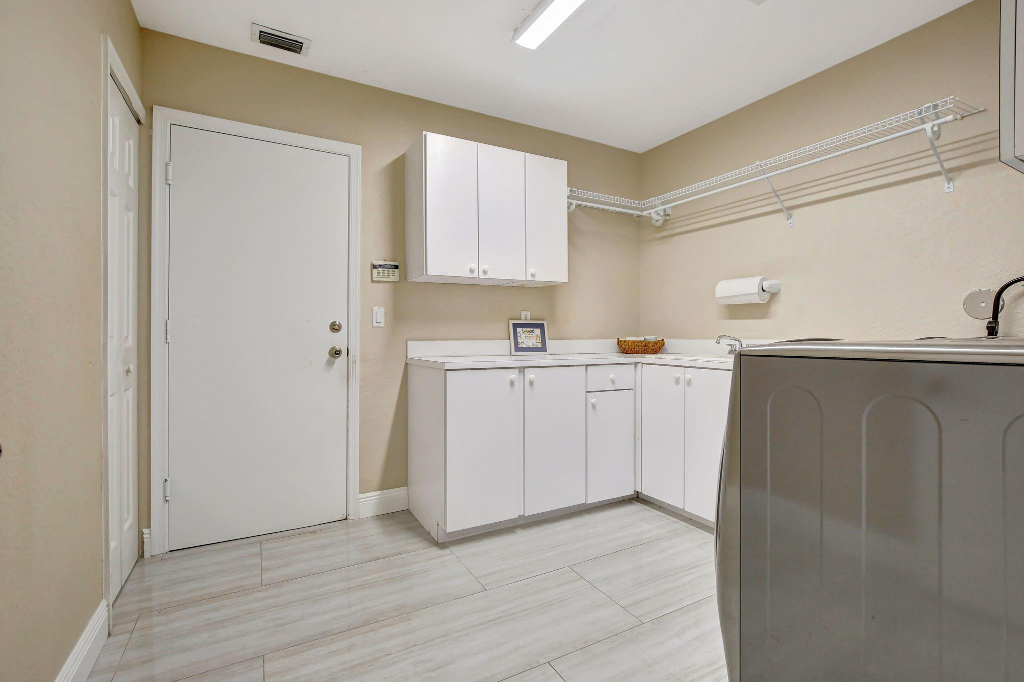 2529 Eagle Run Circle Fort Lauderdale, FL 33327 - Photo 63 of 74 a view of a kitchen with sink and cabinets