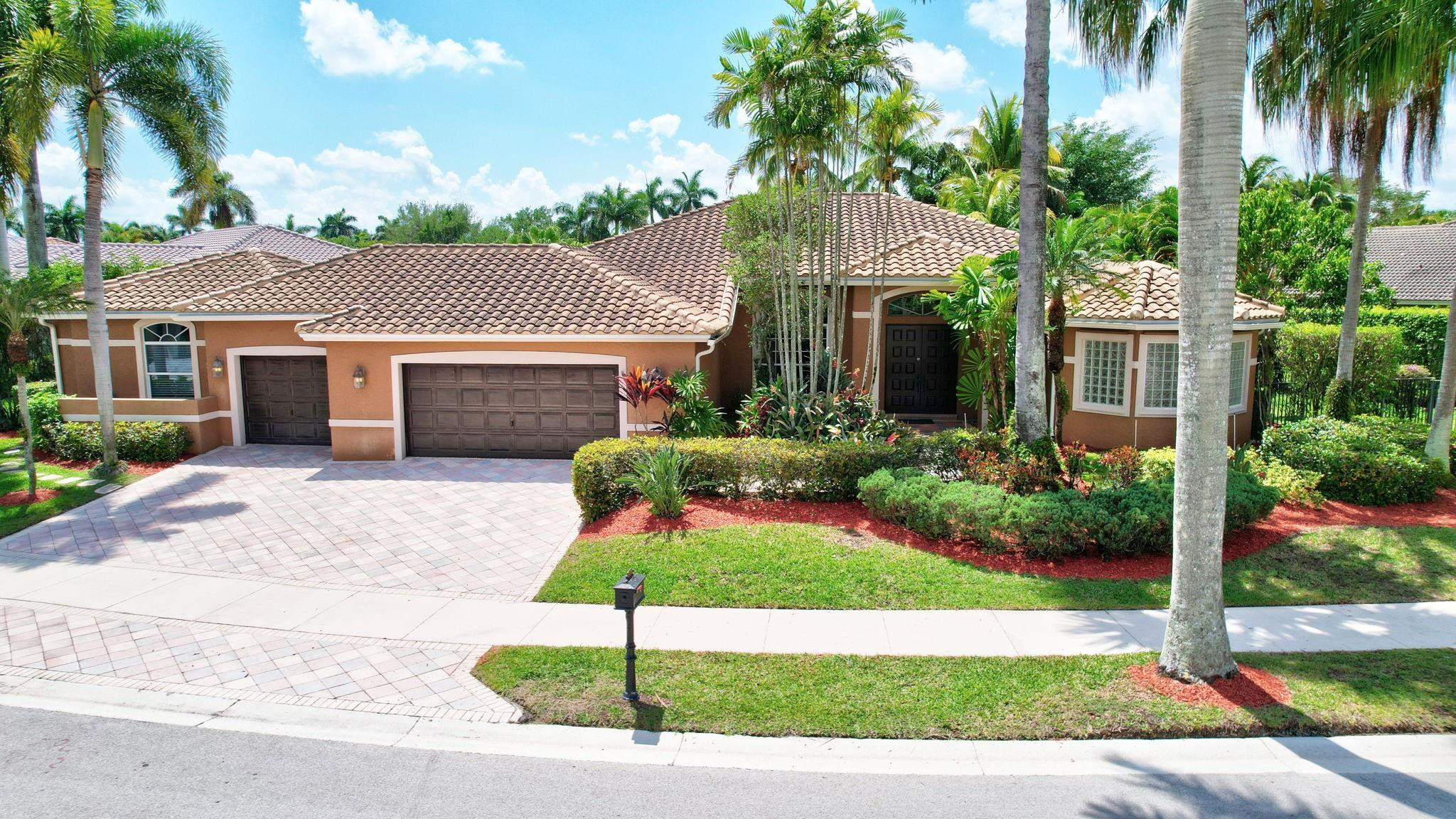 2529 Eagle Run Circle Fort Lauderdale, FL 33327 - Photo 65 of 74 a front view of a house with a garden and plants