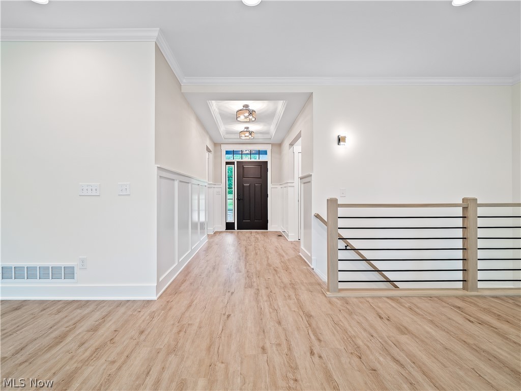32 Brookside Lane North Ridgeville, OH 44039 - Photo 18 of 50 Entryway featuring light wood-style flooring, crown molding, wainscoting, and recessed lighting