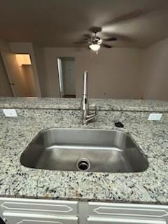 1302 Crescent Street Denton, TX 76201 - Photo 12 of 24 Kitchen view of light stone countertops and a ceiling fan