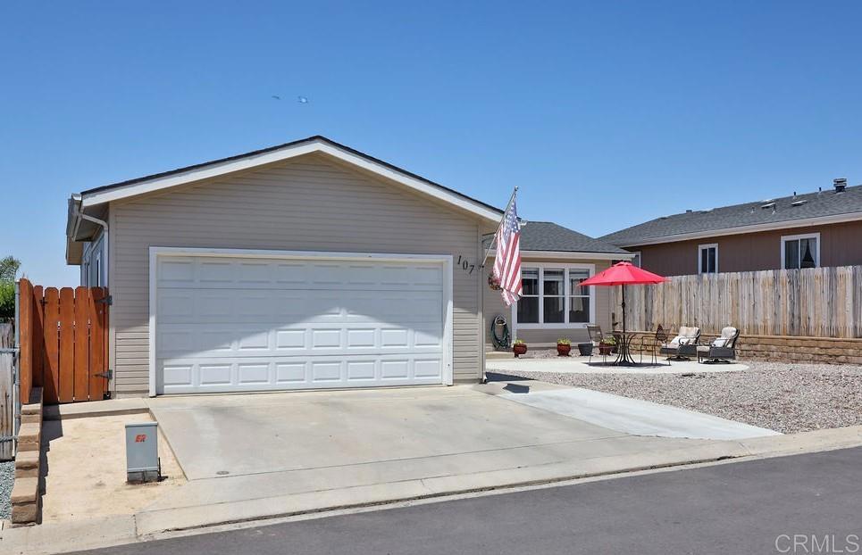 15935 Spring Oaks Road, Unit 107 El Cajon, CA 92021 - Photo 2 of 23 a front view of a house with a garage