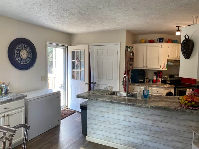 a view of kitchen with sink and wooden floor