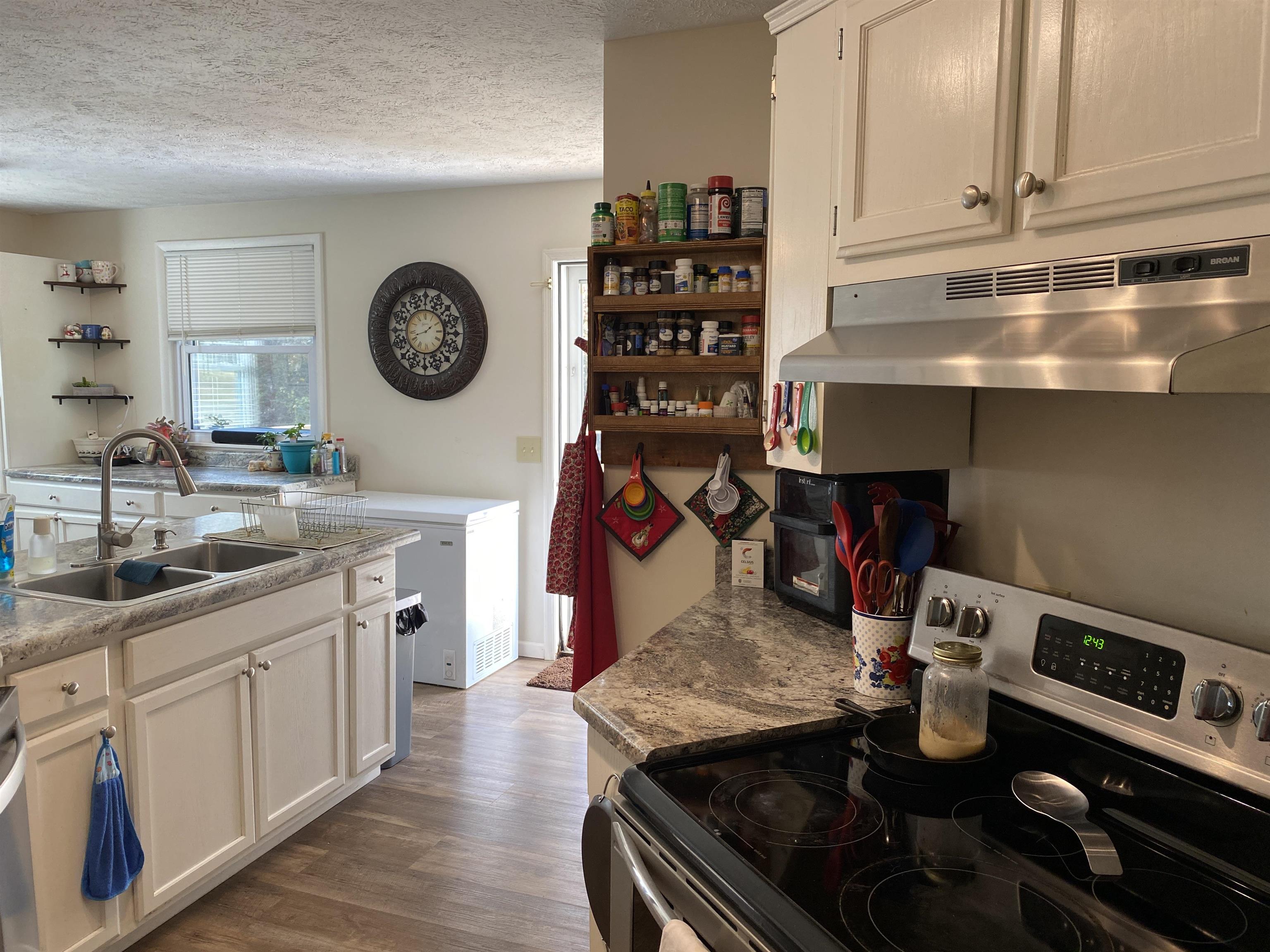 140 Ancil Way Savannah, TN 38372 - Photo 16 of 37 a kitchen with a sink a stove and cabinets