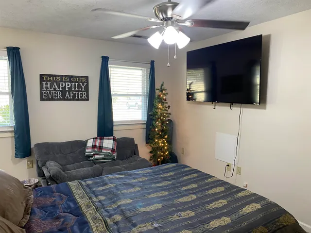 a bedroom with a bed and a flat screen tv