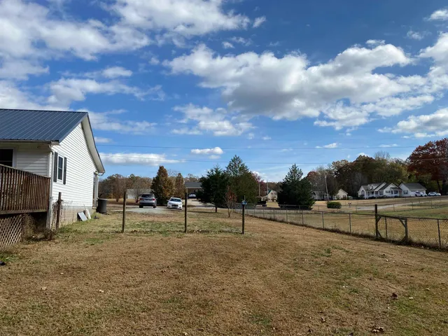 a view of a house with a yard and sitting area