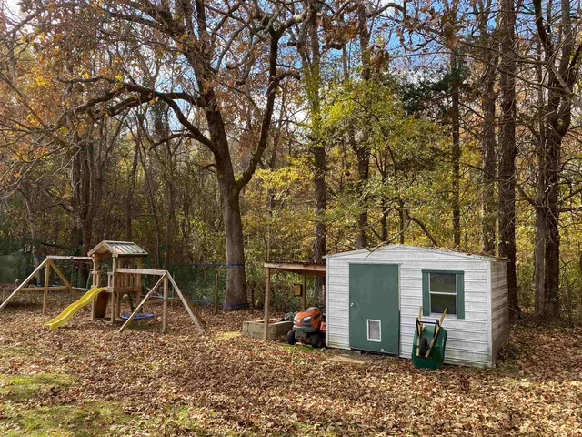a view of a swimming pool with an outdoor seating and a yard