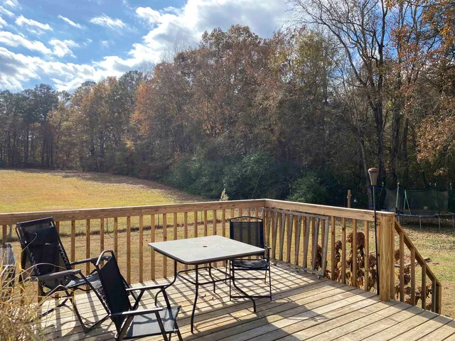 a view of a patio with wooden floor and barbeque oven
