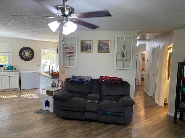 a living room with furniture and a mirror