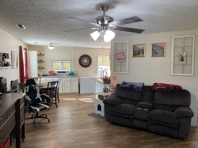 a living room with furniture and a clock