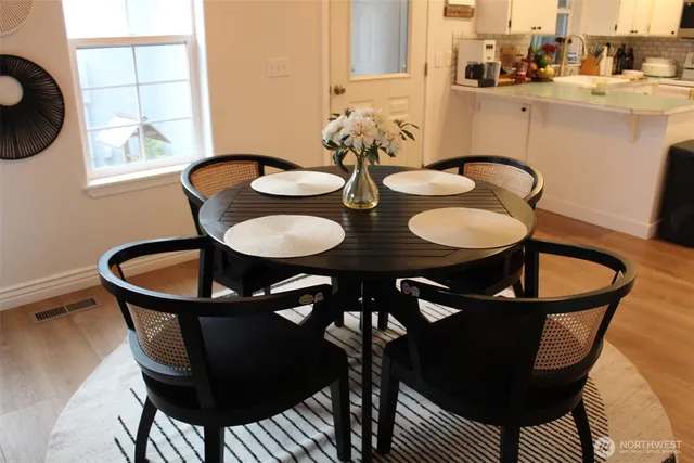 a dining room with furniture and window