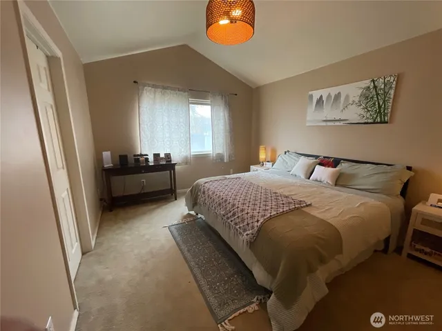 a bedroom with a bed and window