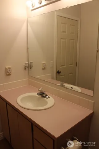 a bathroom with a sink and a mirror