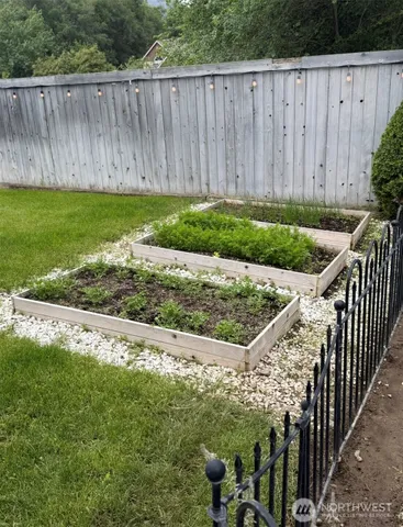 a view of a backyard with wooden fence