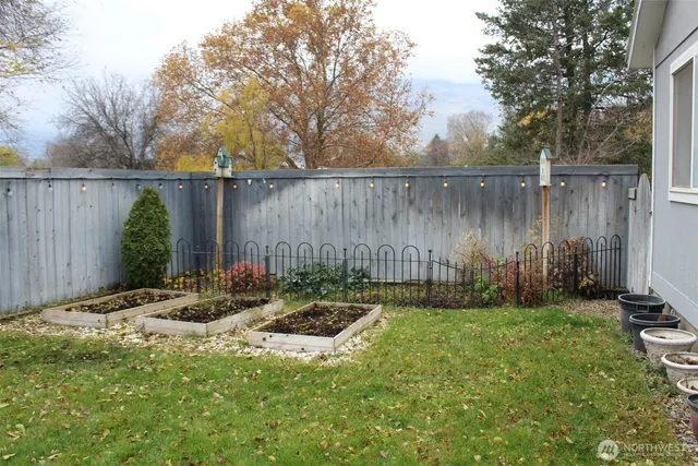 a backyard of a house with lots of green space and fountain