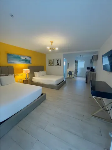 a kitchen with stainless steel appliances granite countertop a sink and a refrigerator