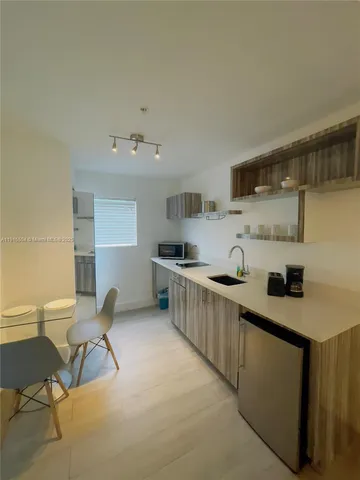 a bathroom with a double vanity sink toilet and shower