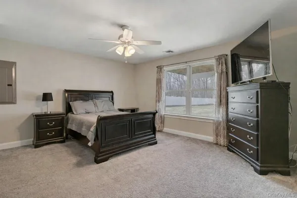 a bedroom with a bed and a tv on the dresser