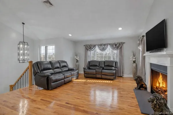 a living room with furniture a flat screen tv and a fireplace