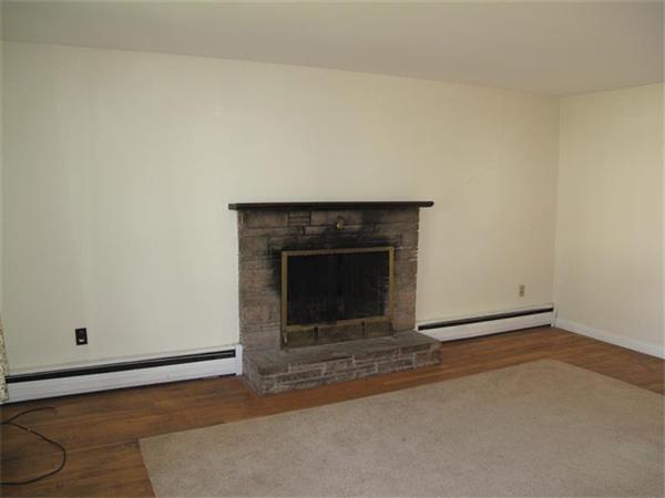 10 Stacy Street Randolph, MA 02368 - Photo 3 of 8 an empty room with a fireplace