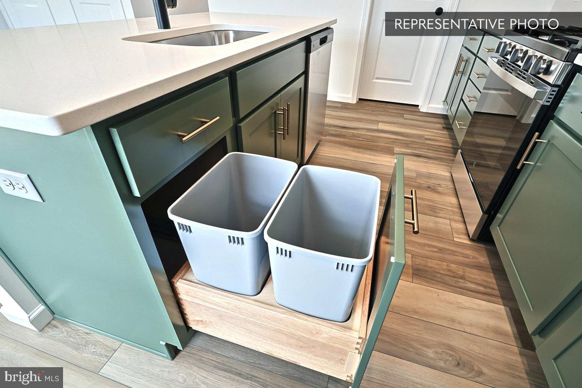 Black Cherry Plan At Hills Spring Grove, PA 17362 - Photo 18 of 42 a view of washer and dryer with wooden floor