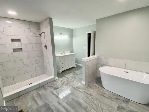 a spacious bathroom with a bathtub and a shower