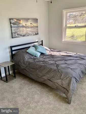 a bedroom with a bed and window