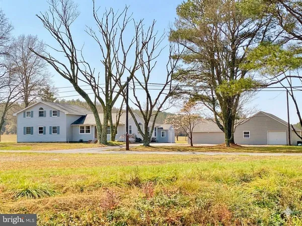 a house view with swimming pool in front of big house