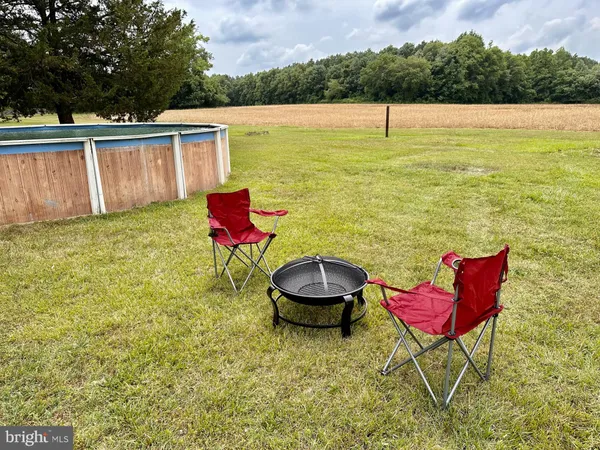 a view of a swimming pool with a chair and a table in the patio