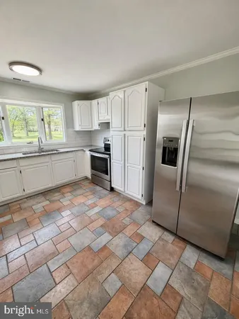 a large kitchen with cabinets and stainless steel appliances