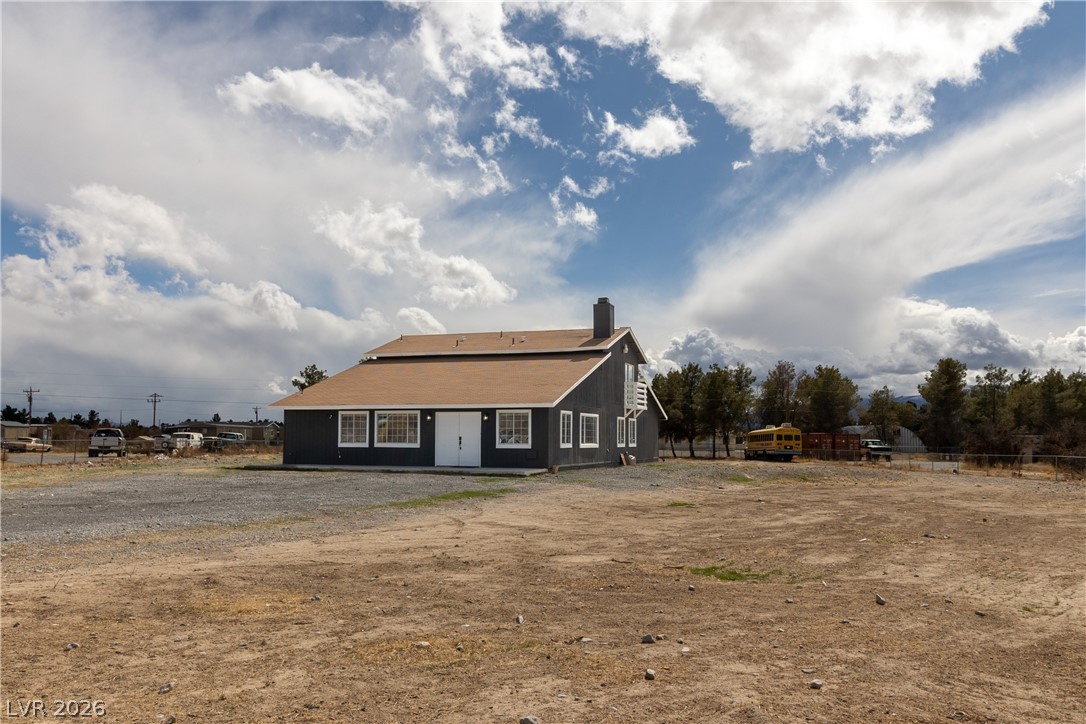 1891 Brian Road Pahrump, NV 89048 - Photo 49 of 50 Rear view of house with a chimney