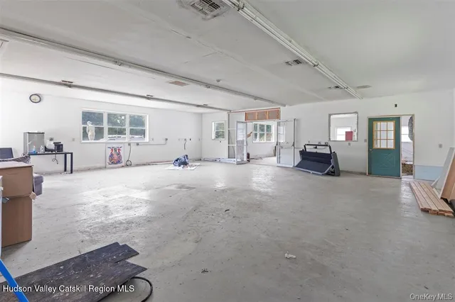 a view of a livingroom with furniture fireplace and windows