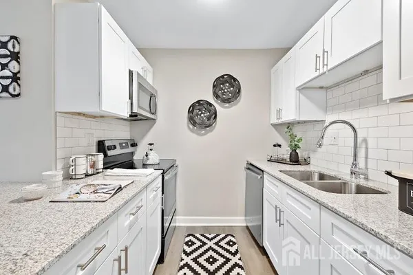 a kitchen with a sink a stove and cabinets