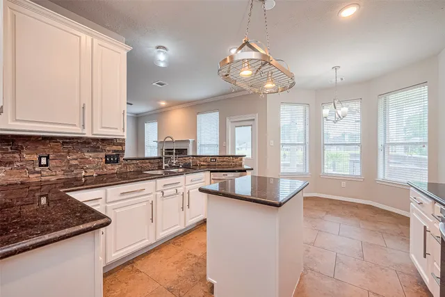 a kitchen with stainless steel appliances granite countertop a sink dishwasher stove and refrigerator